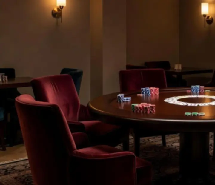 A softly lit poker room with plush seating and neatly arranged tables